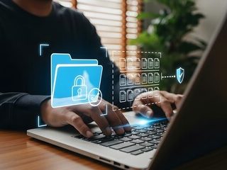 A close-up of a filing cabinet filled with various coloured folders and documents.