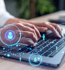 Data Privacy Services A man with glasses studies digital data on a glowing display.