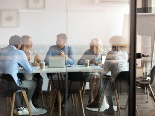 A close-up of a filing cabinet filled with various coloured folders and documents.